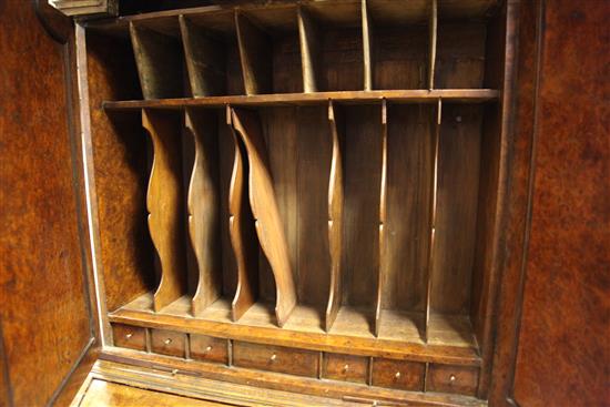 A Queen Anne walnut and featherbanded bureau cabinet, W.3ft 5in.